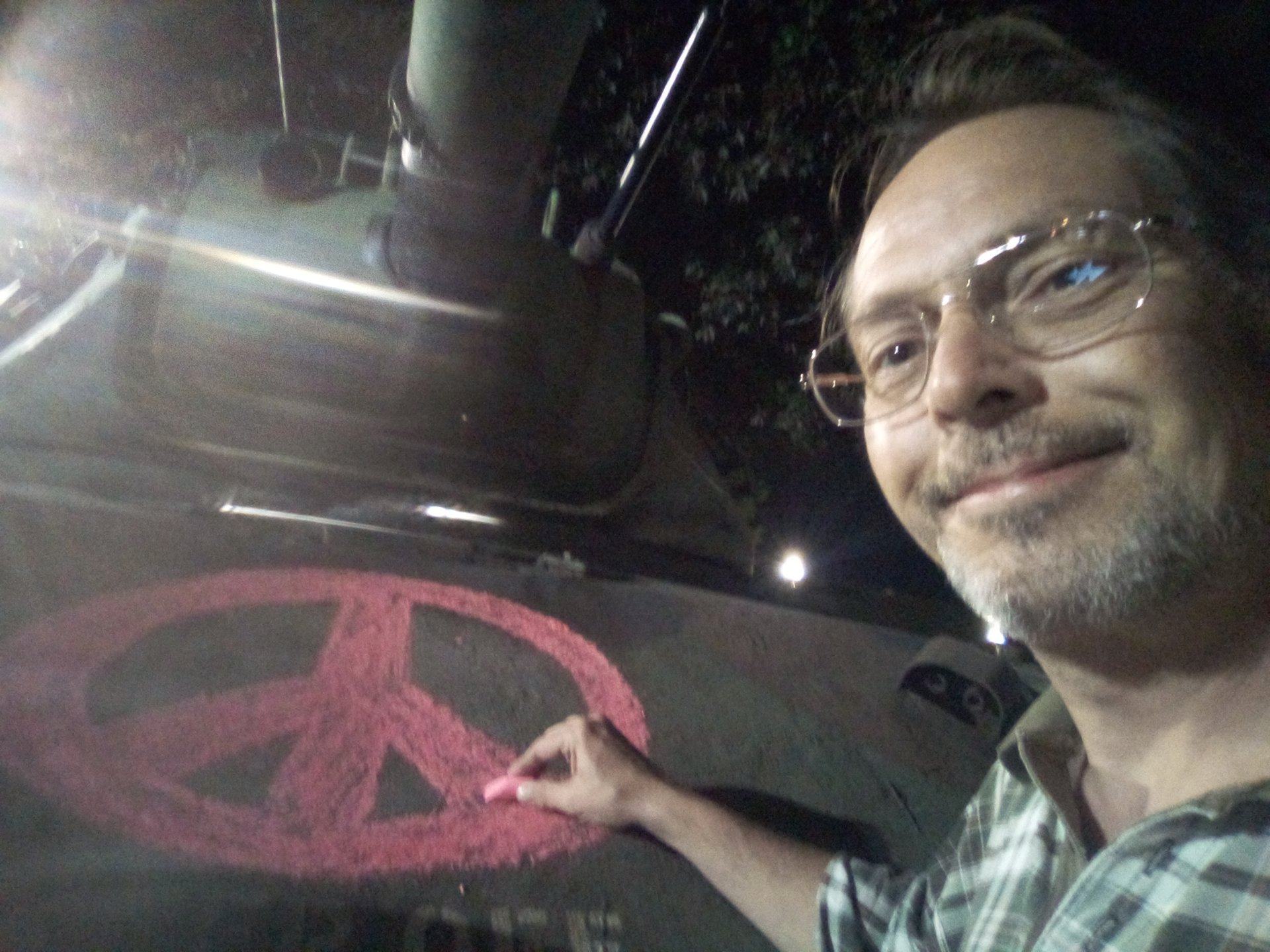 Donnie Love drawing a peace sign on the front of te tank with chalk